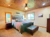 The master bedroom is located on the main floor with a King bed and large window to enjoy the beautiful surroundings.