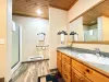 Ensuite bathroom with soaking tub, standing shower, toilet, and sink vanity.