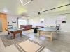 The expansive game room features a pool table, ping pong table, and shuffleboard—perfect for indoor entertainment and group fun.