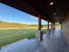 The view from the back porch to the yard and fire pit.