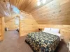 The private sleeping space over the garage offers great flexibility, complete with two cozy beds styled with matching rustic quilts.