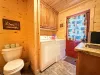 For your ultimate convenience, this efficient utility space features a stacked washer and dryer right alongside a clean toilet and a premium granite-top vanity.