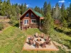 View of the cabin and fire pit. There are 3 cabins close to this property. It is not secluded. 