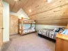 Bedroom #2 located upstairs with a Queen and a bunk bed. Large open room.