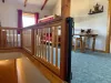 Open bedroom upstairs with child gate.