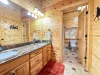 The large upstairs shared bathroom features a double-sink marble vanity and plenty of mirror space, leading into a separate toilet and shower area.