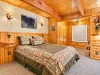 This is a spacious bedroom on the main level with a queen bed and a nook with a twin bed.