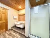 Ensuite bathroom with soaking tub, standing shower, toilet, and sink vanity.