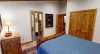View of the hallway and connected bathroom from the third bedrooms bedside.