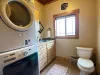 Convenient main-floor half bath equipped with a high-capacity stacked washer and dryer, making quick vacation laundry a breeze.