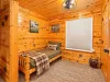 This is a spacious bedroom on the main level with a queen bed and a nook with a twin bed.