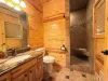 The master suite features a private 3/4 ensuite bathroom complete with a marble-top vanity, toilet, and a spacious custom tile shower.