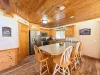 Fully equipped open kitchen with appliances, pots and pans, dishes, utensils, and basic cooking essentials.