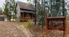 Welcome to Mangy Moose Cabin! This private mountain retreat instantly greets you with authentic rustic signage and a scenic driveway nestled in nature.