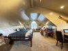 This massive loft over the garage serves as a private apartment, fully equipped with multiple beds, a TV area, and private dining space.