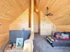 Head upstairs to the expansive open-loft area, showcasing high vaulted ceilings, rich wooden paneling, and a flexible secondary living space for the whole family.