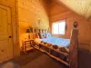 Bright and inviting, the third bedroom features a beautiful log-framed Queen bed styled with a charming wilderness-themed quilt.