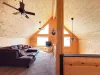 The cozy upstairs loft living room comes complete with a massive plush sectional sofa, a flat-screen TV, and authentic mountain-cabin decor.
