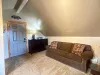 Beside the beds is a comfortable couch for seating others, creating an inviting spot to gather, read, or plan your day's adventures.