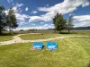 Have some outdoor fun with a game of cornhole on the spacious, manicured lawn under the beautiful blue sky.