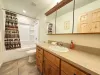 Main level bathroom with shower/tub combo, toilet, and sink vanity.