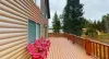 Soak in the fresh mountain air on the expansive open sun deck, featuring vibrant red Adirondack chairs that offer front-row seats to the cabin’s scenic scenery.
