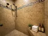 Step into the luxurious master ensuite shower, beautifully designed with premium tiling, dual shower heads, and built-in bench seating.