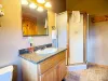 This private 3/4 bathroom above the garage includes a dedicated standing shower stall, ensuring guests have everything they need close by.