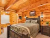 This is a spacious bedroom on the main level with a queen bed and a nook with a twin bed.