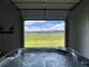 Unwind in the bubbling hot tub while framing panoramic views of the open plains and majestic distant mountains.
