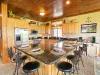 Cook and chat together around the expansive kitchen island. This fully equipped space features gorgeous granite countertops and counter seating.