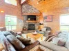 Experience cozy cabin luxury in this spacious living room featuring high