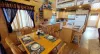 Upon entrance, you are greeted by the dining table and kitchen.