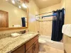 Hallway common bath with a tub and shower.