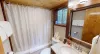 Second bathroom is equipped with a shower tub combo, toilet, and sink vanity.