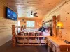 Enjoy a relaxing morning in bed while watching your favorite shows on the large wall-mounted Smart TV, complete with natural light streaming through the window.